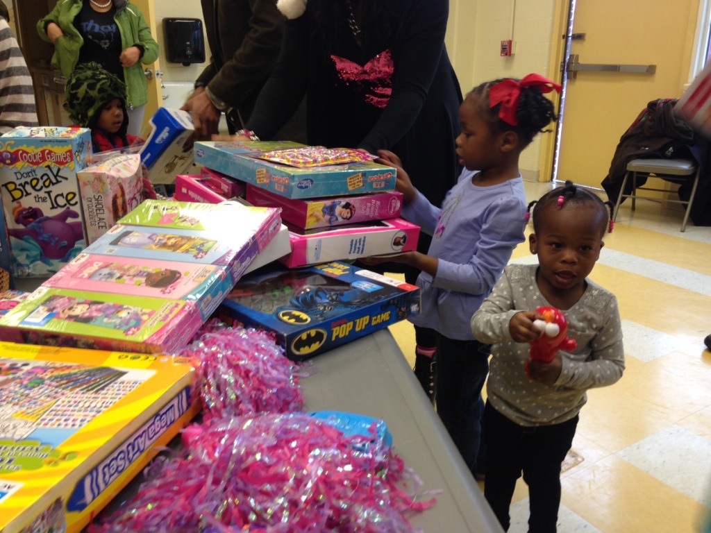 Kids receive gifts in Ward 8. (WTOP/Megan Cloherty)