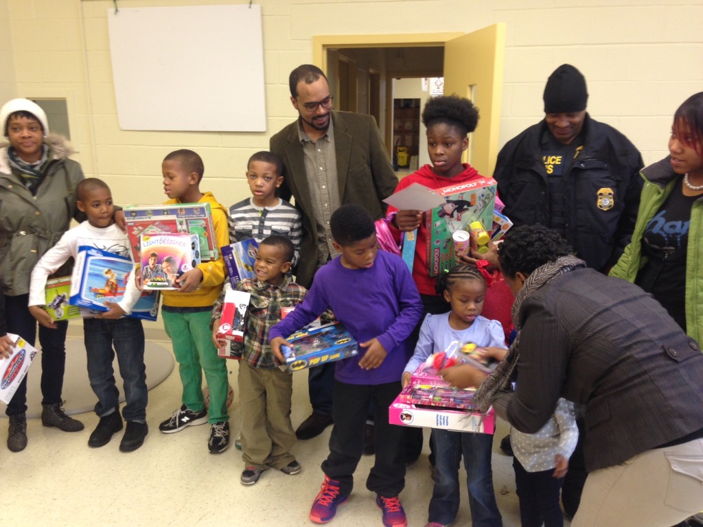 Children pose with their gifts in Ward 8 (WTOP/Megan Cloherty)