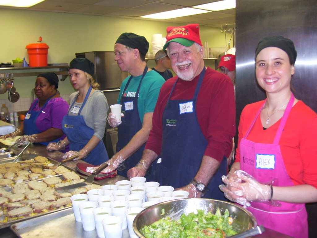 Volunteers prepare and service Christmas breakfast at D.C.'s Miriam's Kitchen. (WTOP/Kathy Stewart)