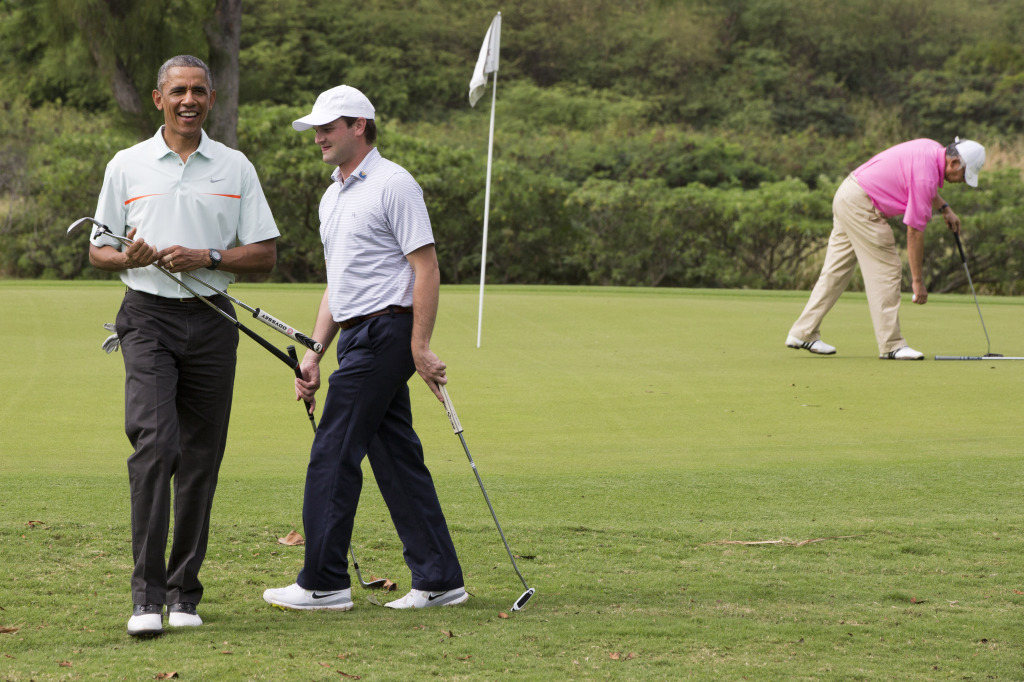 White House aide Joe Paulsen, and Malaysian Prime Minister Najib Razak, right in pink, Wednesday, Dec. 24, 2014, at Marine Corps Base Hawaii's Kaneohe Klipper Golf Course in Kaneohe, Hawaii during the Obama family vacation. (AP Photo/Jacquelyn Martin)