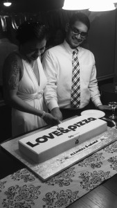 Katie Hendrickson and her fiancé aren't the only ones to have an &pizza inspired wedding. Here, &pizza employees Ashaad and Alejandra, who met on the job, cut into their wedding cake, modeled after the local chain's to-go boxes. (Courtesy &pizza)