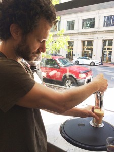 Dolcezza owner Robb Duncan pours a nitro coffee at the store's newest location at CityCenter. (WTOP/Rachel Nania) 