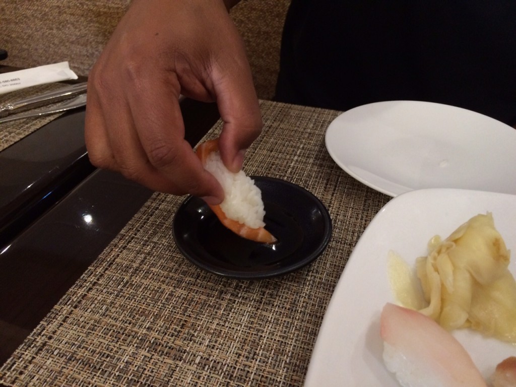 Using your gingers or chopsticks, turn the nigiri to the side and dip the fish into the soy. Then, eat the nigiri fish-side first, for maximum flavor. (WTOP/Rachel Nania) 