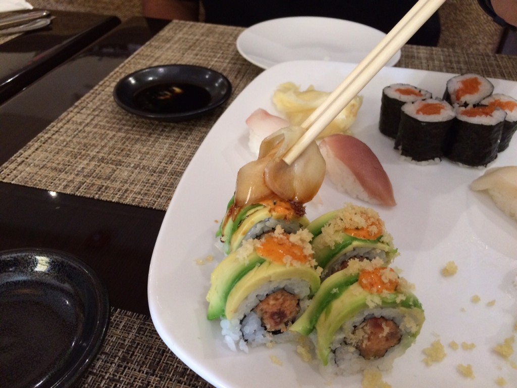 Ginger can also be used as a vehicle to deliver soy sauce to your sushi rolls. Using chopsticks, dip a slice of ginger into the soy sauce, and then using the ginger, brush the soy onto your sushi roll. (WTOP/Rachel Nania)