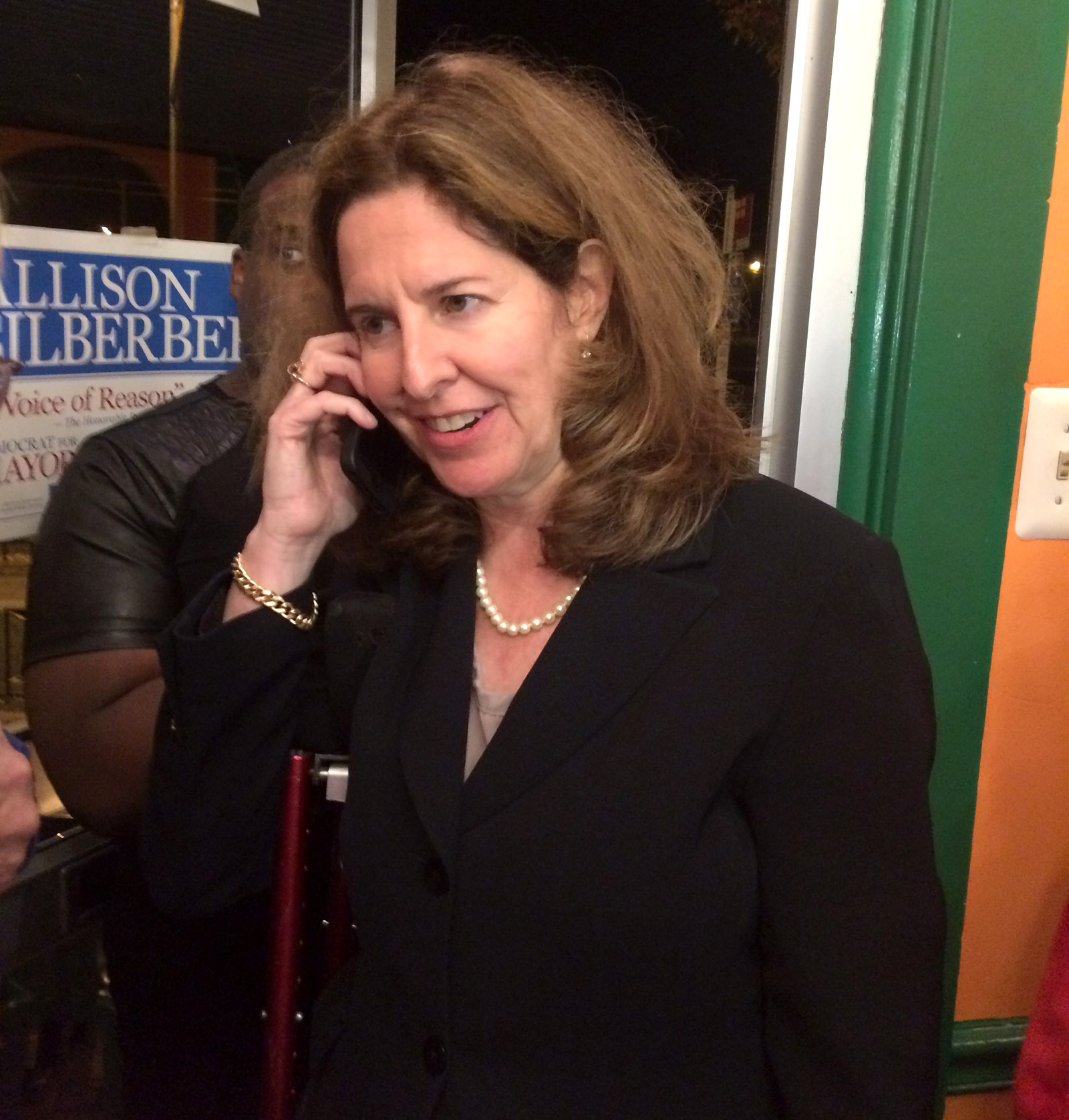 Alexandria Mayor-elect Allison Silberberg talks on the phone during her election night celebration in Del Ray on Tuesday, Nov. 3, 2015. (WTOP/Dick Uliano)