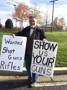 Dave Carlin, of Uncommon Arms, Kensington, Md., staked out the parking lot entrance of First Baptist Church of Glenarden to try to buy people’s firearms before they turned them in for destruction during a gun exchange event Saturday, Nov. 21, 2105. Carlin is a federally licensed gun dealer and collector. (WTOP/Dick Uliano)
