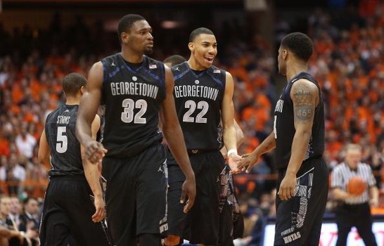 SYRACUSE, NY - FEBRUARY 23: Moses Ayegba #32, Otto Porter Jr. #22 and D'Vauntes Smith-Rivera #4 of the Georgetown Hoyas celebrate their win over the Syracuse Orange during the game at the Carrier Dome on February 23, 2013 in Syracuse, New York. (Photo by Nate Shron/Getty Images)