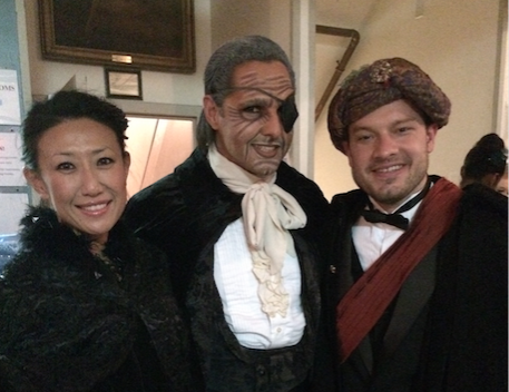 NBC-4's Eun Yang (left) and WTOP's Jason Fraley (right) pose backstage with dancer Luis Torres during their cameo appearances in "The Nutcracker" at Warner Theatre. (Courtesy Washington Ballet)