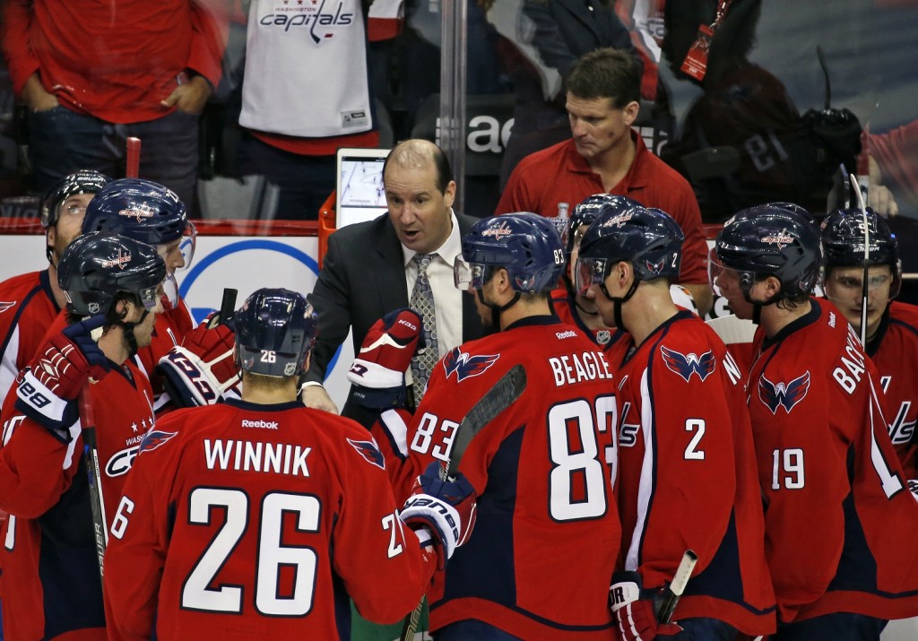 Washington Capitals assistant coach Todd Reirden talks with the team during a timeout in the third period of Game 1 in the first round of the NHL Stanley Cup hockey playoffs against the Philadelphia Flyers, Thursday, April 14, 2016, in Washington. The Capitals won 2-0. (AP Photo/Alex Brandon)