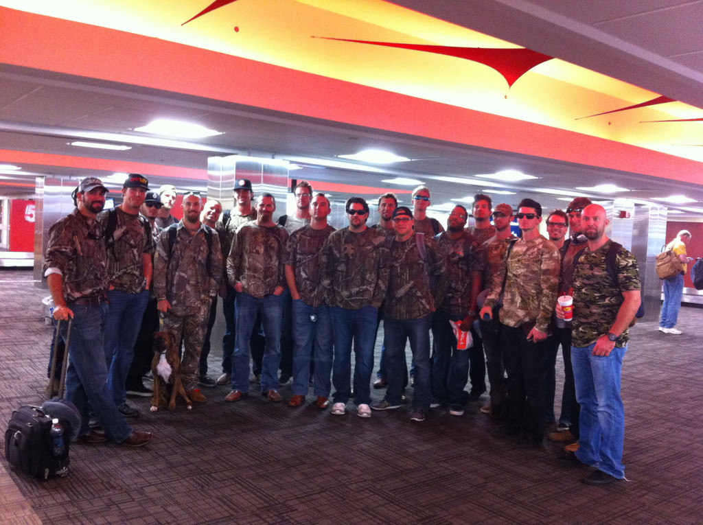 The 2013 Zephyrs team, wearing matching camouflage shirts as they wait at baggage claim. (Tim Grubbs)