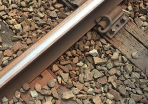The old-style fastener used to keep rails from sliding apart is shown on the bottom right. The newer style of fastener, which are screwed into the ties, is show at the top right. Metro has long-term plans to replace the older style, which has been cited as at least partially to blame for a number of derailments. (WTOP/Max Smith)