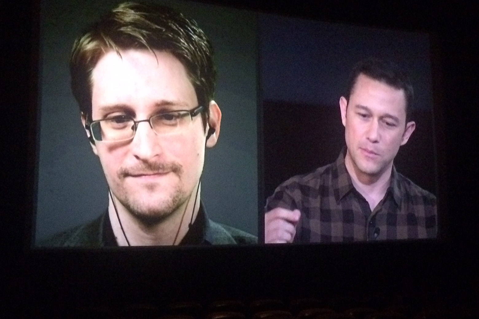 Edward Snowden video conferences (left) with Joseph Gordon-Levitt (right) during "Snowden Live" at AMC Mazza Gallerie in Washington D.C. (WTOP/Jason Fraley)