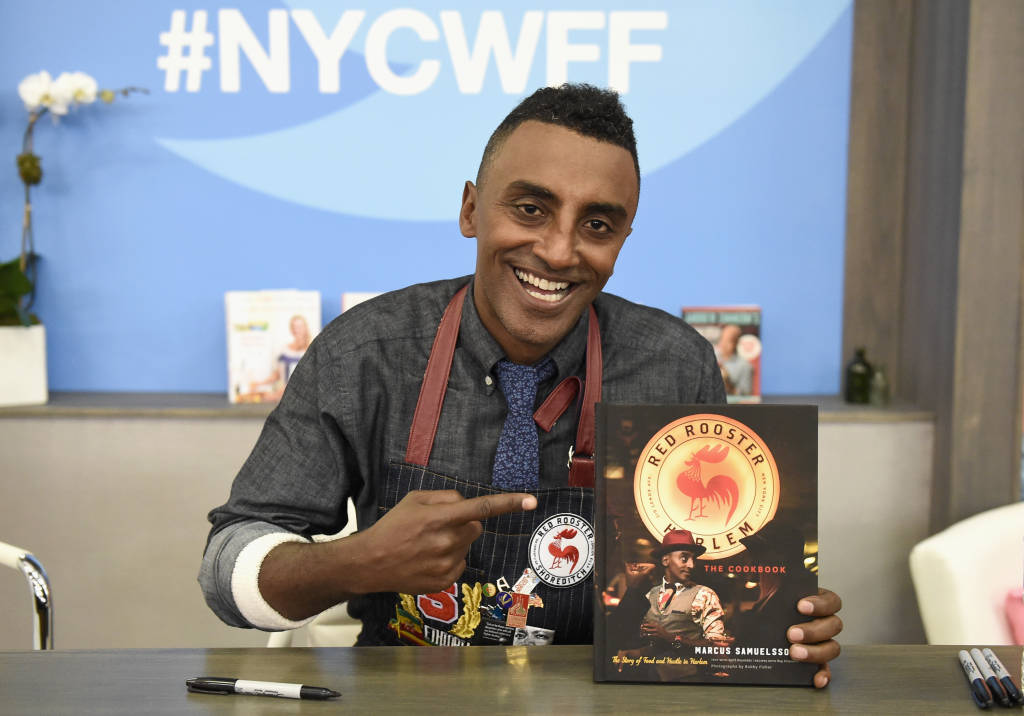NEW YORK, NY - OCTOBER 16:  Chef Marcus Samuelsson poses with his cookbook at a signing during the Grand Tasting presented by ShopRite featuring Samsung culinary demonstrations presented by MasterCard at the Food Network & Cooking Channel New York City Wine & Food Festival presented by Coca-Cola at Pier 94 on October 16, 2016 in New York City.  (Photo by Nicholas Hunt/Getty Images for NYCWFF)