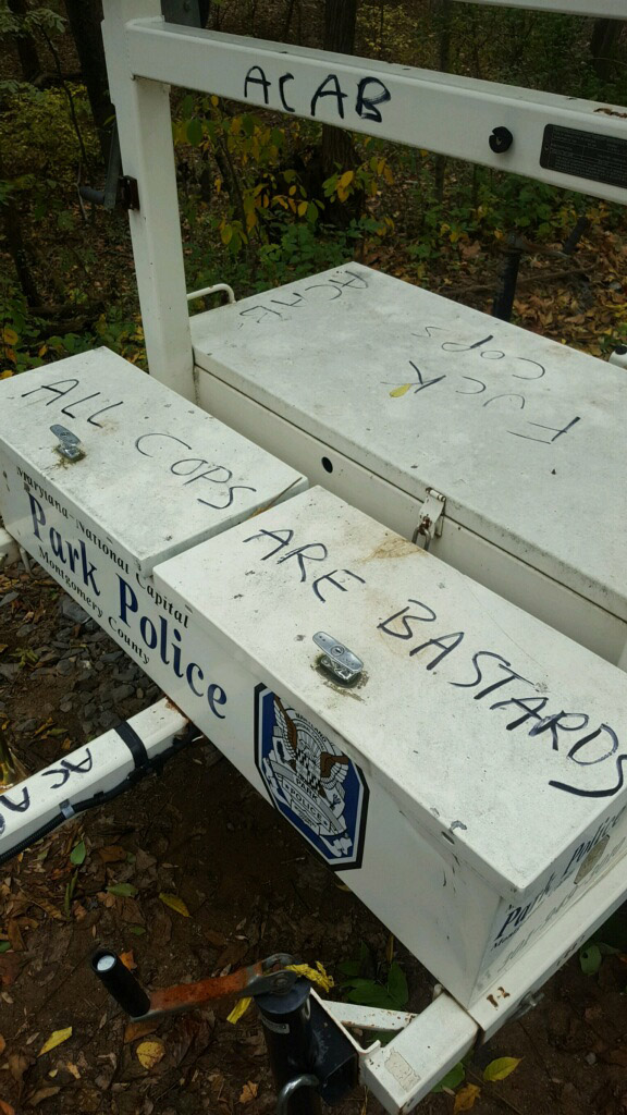 Vandals scrawled the words "All Cops Are Bastards" and other foul language on an electronic police message board near the intersection of the Capital Crescent Trail and Little Falls Parkway - the scene of a fatal bike crash earlier this month. Police have stepped up safety patrols in the area and police said that bicyclists have resisted their efforts. (Courtesy Maryland-National Capital Park Police)