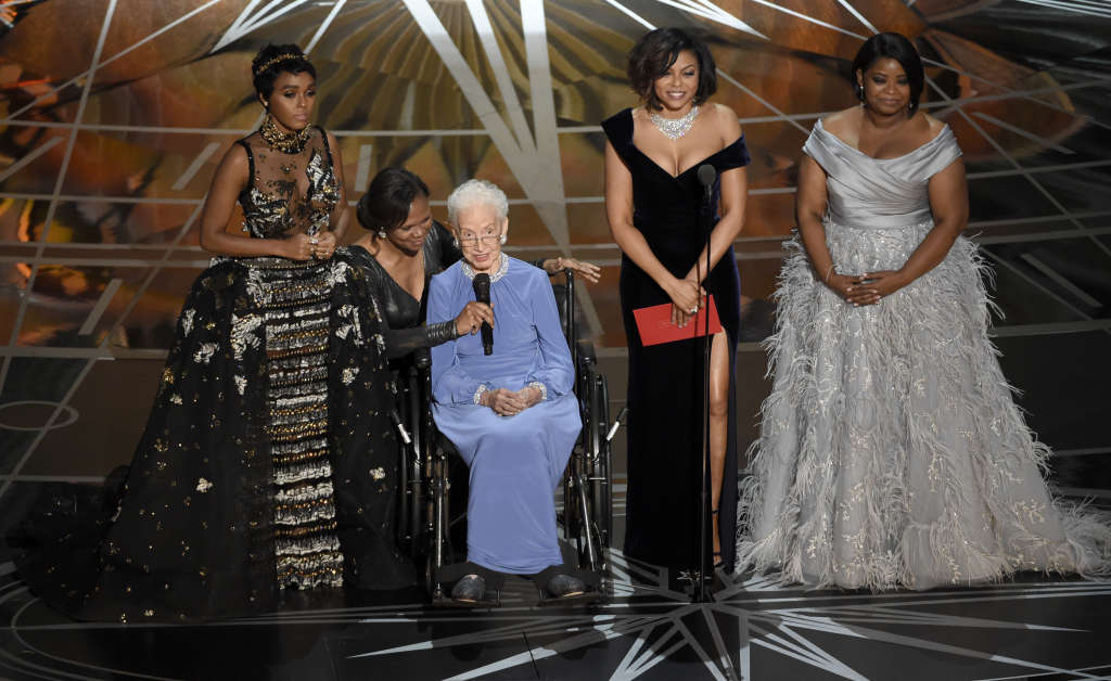 Janelle Monae, left, Taraji P. Henson, second right and Octavia Spencer, right, introduce Katherine Johnson, seated, the inspiration for "Hidden Figures," as they present the award for best documentary feature at the Oscars on Sunday, Feb. 26, 2017, at the Dolby Theatre in Los Angeles. (Photo by Chris Pizzello/Invision/AP)