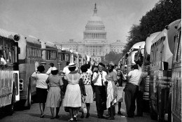 With the U.S. Capitol in the background, passengers for charter busses walk along a service roadway of the Mall in Washington, August 28, 1963, to find their transportation home after a civil rights demonstration estimated by police at more than 200,000 people.  (AP Photo)