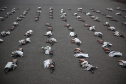 Guns and gloves of India's Air Force soldiers lie on a road during rehearsals for the upcoming Republic Day parade in New Delhi, India, Tuesday, Dec. 23, 2014. India marks Republic Day on Jan. 26 with military parades across the country. (AP Photo/Tsering Topgyal)