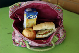 A student's lunch box brought from home sits on display at an elementary school in Quito, Ecuador, Tuesday, May 6, 2014. The lunch consists of a sandwich of ham, cheese, tomato and lettuce, a boxed oatmeal drink, and an apple. (AP Photo/Dolores Ochoa)
