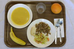 A school lunch at El Caminet del Besos kindergarten is pictured in Barcelona, Spain, Tuesday, May 6, 2014. The lunch is composed of cream of vegetable soup, pan-fried breast of veal with salad, a piece of bread, an orange or banana and water. Most countries seem to put a premium on feeding school children a healthy meal at lunchtime. U.S. first lady Michelle Obama is on a mission to make American school lunches healthier too. (AP Photo/Manu Fernandez)