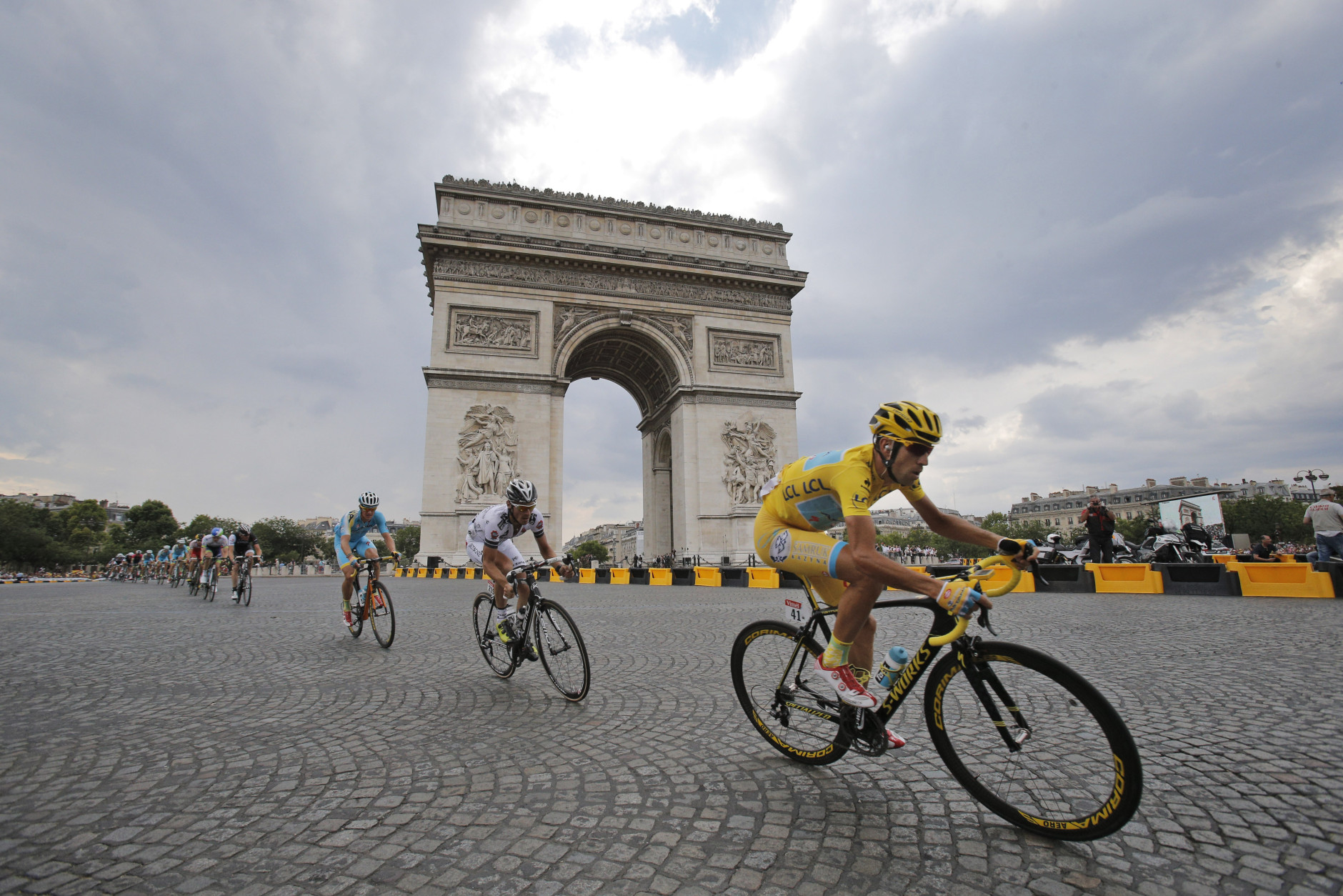 FOR USE AS DESIRED, YEAR END PHOTOS - FILE - Italy's Vincenzo Nibali, wearing the overall leader's yellow jersey, passes the Arc de Triomphe during the twenty-first and last stage of the Tour de France cycling race over 137.5 kilometers (85.4 miles) with start in Evry and finish in Paris, France, Sunday, July 27, 2014. (AP Photo/Christophe Ena, File)