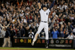 FOR USE AS DESIRED, YEAR END PHOTOS - FILE - New York Yankee Derek Jeter jumps after hitting the game-winning single against the Baltimore Orioles in the ninth inning of a baseball game, Thursday, Sept. 25, 2014, in New York. The Yankees won 6-5. It was Jeter's last home game of his career at Yankee Stadium.  (AP Photo/Julie Jacobson, File)
