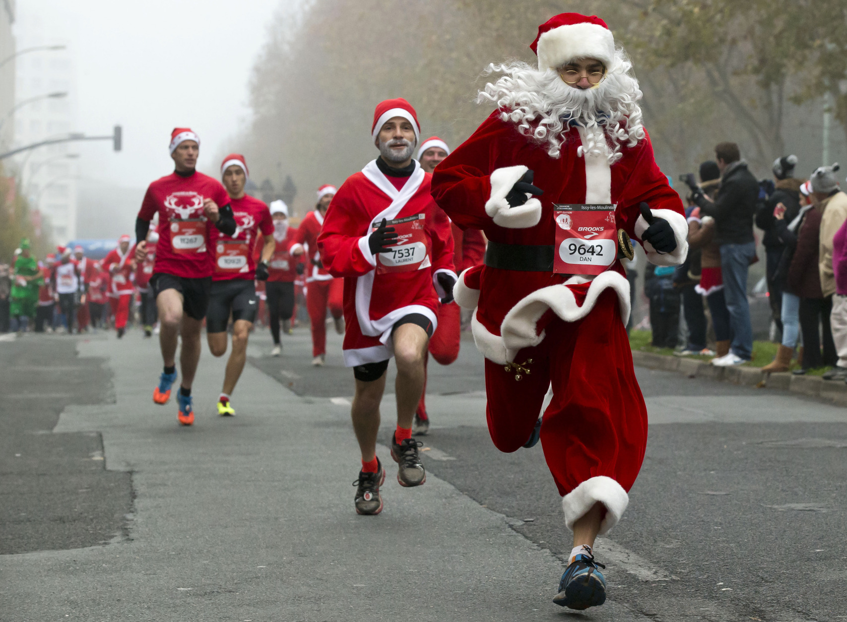 FILE - A Sunday, Dec. 14, 2014 file photo showing runners, dressed as Santa Claus, as they take part in the 38th "Christmas Corrida Race" in the streets of Issy Les Moulineaux, on the western outskirts of Paris. Over 3,000 runners participated in the 10 kilometer (6,25 mile) run. (AP Photo/Michel Euler, File)