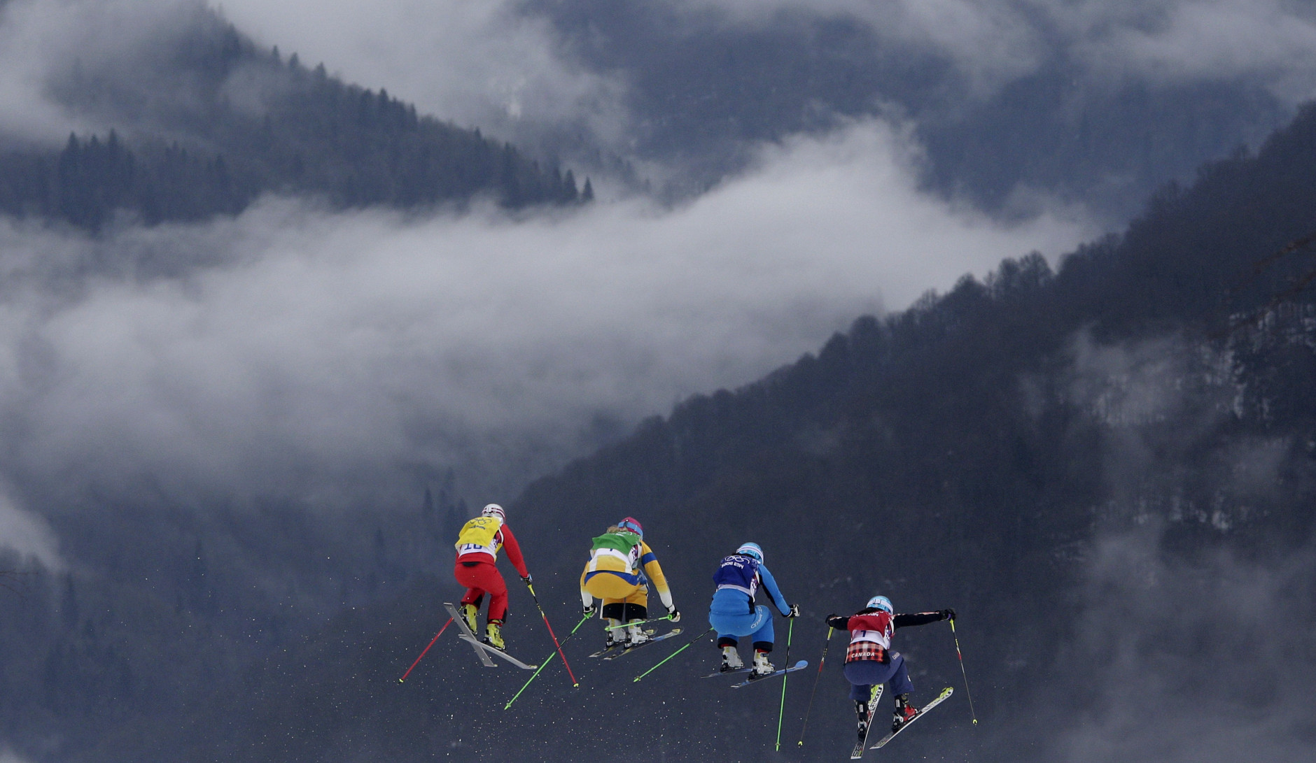 FOR USE AS DESIRED, YEAR END PHOTOS - FILE - Switzerland's Fanny Smith, from left, Sweden's Anna Holmlund, Austria's Katrin Ofner and Canada's Kelsey Serwa compete during their ski cross race at the 2014 Winter Olympics, Friday, Feb. 21, 2014, in Krasnaya Polyana, Russia. (AP Photo/Matthias Schrader, File)