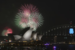 Fireworks explode over the Opera House and the Harbour Bridge during New Years Eve celebrations in Sydney, Australia, Wednesday, Dec. 31, 2014. Thousands of people crammed into Lady Macquaries Chair to watch the annual fireworks show. (AP Photo/Rob Griffith)