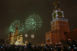 The projection of Spassky (Saviour) tower is seen over the scaffold covering the tower, which is user renovation, as fireworks explode over the Red Square during the New Year celebration, in Moscow, Russia, Thursday, Jan. 1, 2015. (AP Photo/Denis Tyrin)