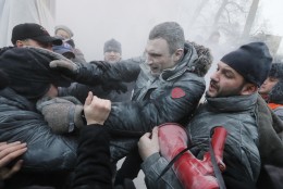 FOR USE AS DESIRED, YEAR END PHOTOS - FILE - Opposition leader and former WBC heavyweight boxing champion Vitali Klitschko, center, is attacked and sprayed with a fire extinguisher as he tries to stop the clashes between police and protesters  in central Kiev, Ukraine, Sunday, Jan. 19, 2014. (AP Photo/Efrem Lukatsky, File)