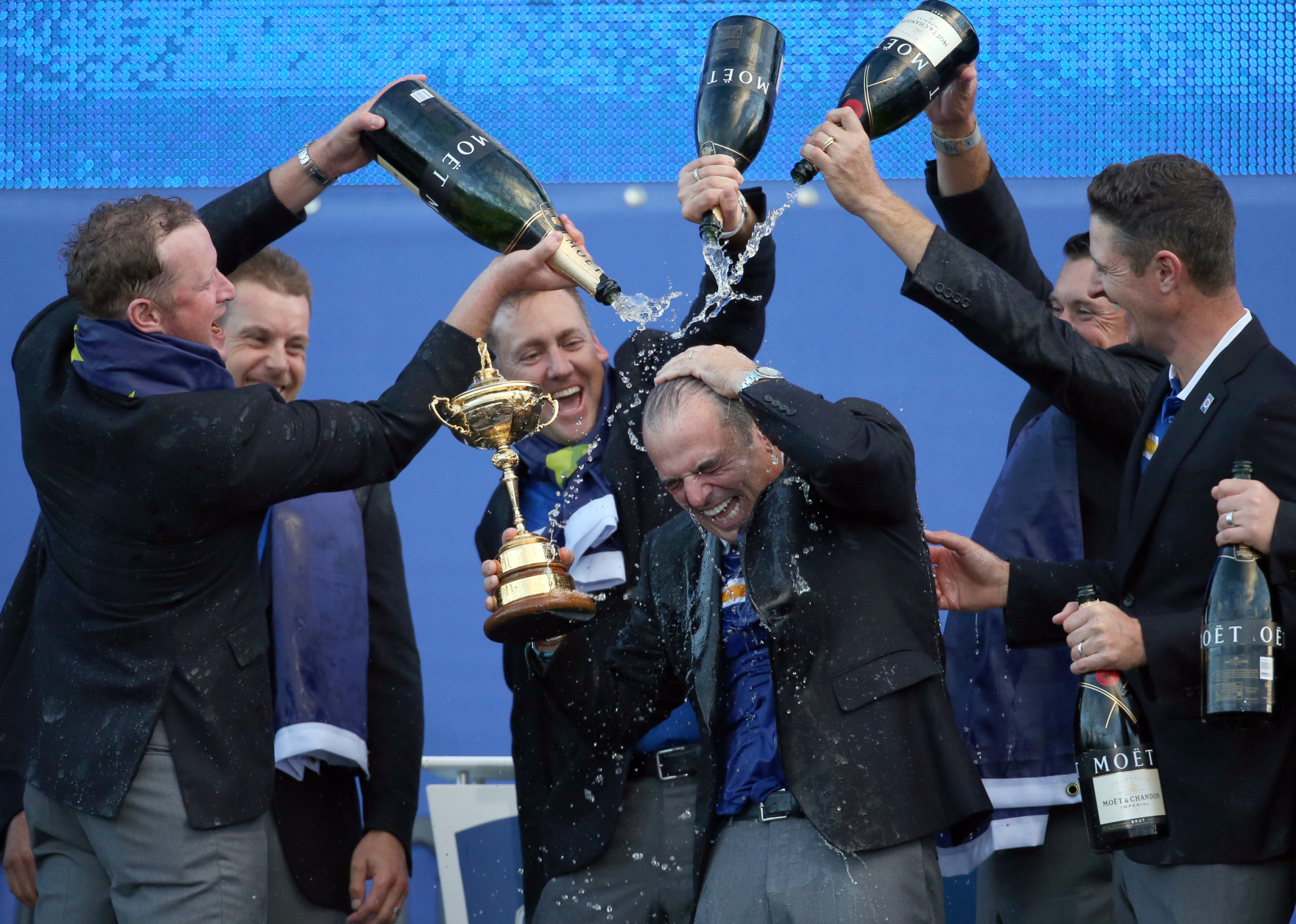 FOR USE AS DESIRED, YEAR END PHOTOS - FILE - From left, Europe's players Jamie Donaldson, Henrik Stenson, Ian Poulter, Lee Westwood and Justin Rose pour champagne over captain Paul McGinley as they celebrate winning the 2014 Ryder Cup golf tournament, at Gleneagles, Scotland, Sunday, Sept. 28, 2014. (AP Photo/Scott Heppell, File)