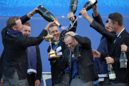 FOR USE AS DESIRED, YEAR END PHOTOS - FILE - From left, Europe's players Jamie Donaldson, Henrik Stenson, Ian Poulter, Lee Westwood and Justin Rose pour champagne over captain Paul McGinley as they celebrate winning the 2014 Ryder Cup golf tournament, at Gleneagles, Scotland, Sunday, Sept. 28, 2014. (AP Photo/Scott Heppell, File)