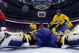FOR USE AS DESIRED, YEAR END PHOTOS - FILE - Canada forward Sidney Crosby scores a goal on Sweden goaltender Henrik Lundqvist during the second period of the men's gold medal ice hockey game at the 2014 Winter Olympics, Sunday, Feb. 23, 2014, in Sochi, Russia. (AP Photo/Julio Cortez, Pool, File)
