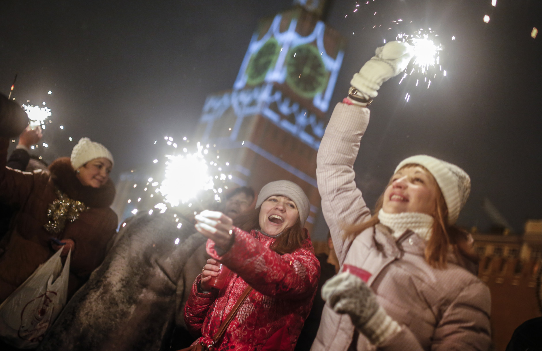 People light sparklers as they celebrate the New Year at the Red Square in Moscow, Russia, Thursday, Jan. 1, 2015. (AP Photo/Denis Tyrin)