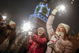 People light sparklers as they celebrate the New Year at the Red Square in Moscow, Russia, Thursday, Jan. 1, 2015. (AP Photo/Denis Tyrin)