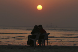 A Pakistani couple enjoys the last sunset of the year at Karachi beach, Wednesday, Dec. 31, 2014, in Pakistan. (AP Photo/Fareed Khan)