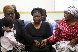 FOR USE AS DESIRED, YEAR END PHOTOS - FILE - Garteh Korkoryah, center, mother of Thomas Eric Duncan, is comforted during a memorial service for her son, Saturday, Oct. 18, 2014, in Salisbury, N.C. Duncan died of Ebola in Dallas on Oct. 8. (AP Photo/Nell Redmond, File)