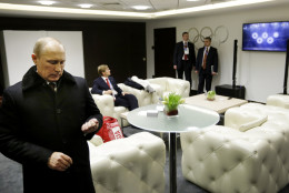 FOR USE AS DESIRED, YEAR END PHOTOS - FILE - Russian President Vladimir Putin waits in the presidential lounge to be introduced at the opening ceremony of the 2014 Winter Olympics as behind him, a TV screen shows the malfunction of the Olympic rings opening at the start of the ceremony, Friday, Feb. 7, 2014, in Sochi, Russia. (AP Photo/David Goldman, File, Pool)