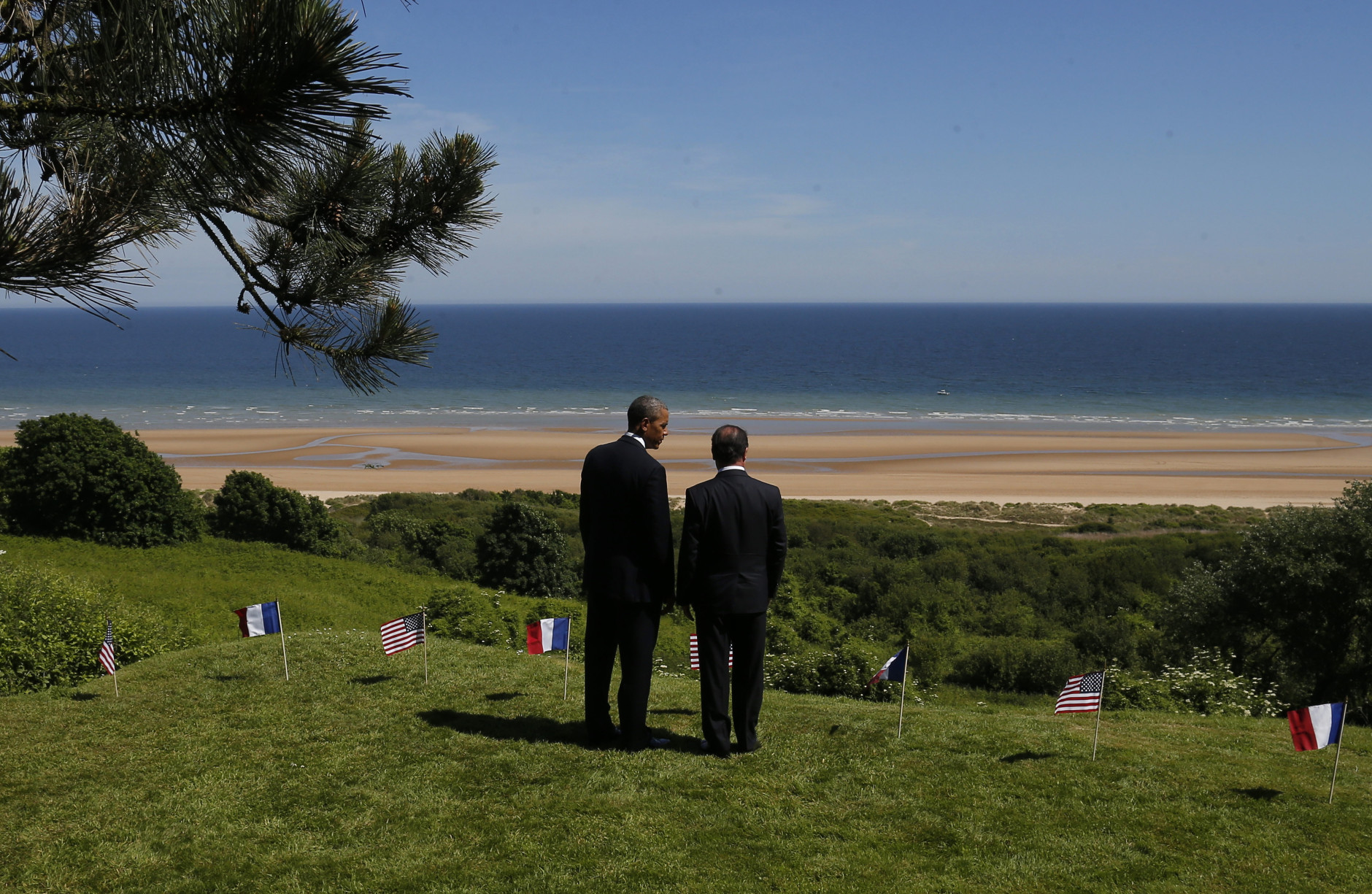 FOR USE AS DESIRED, YEAR END PHOTOS - FILE - U.S. President Barack Obama and French President Francois Hollande look out at Omaha Beach, one of the sites of the Allied soldiers beach landings, at Normandy American Cemetery as they participate in the 70th anniversary of D-Day in Colleville sur Mer in Normandy, France, Friday, June 6, 2014. (AP Photo/Charles Dharapak, File)