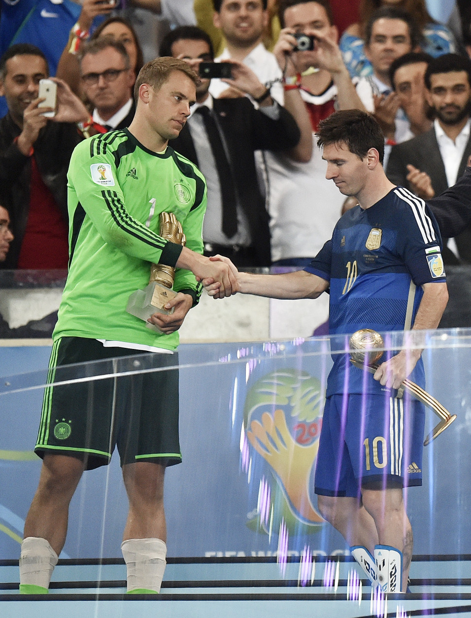 FOR USE AS DESIRED, YEAR END PHOTOS - FILE - Germany's goalkeeper Manuel Neuer, left, winner of the Golden Glove award for best goalkeeper, shakes hands with Argentina's Lionel Messi, winner of the Golden Ball award as the tournament's top player, after the World Cup final soccer match between Germany and Argentina at the Maracana Stadium in Rio de Janeiro, Brazil, Sunday, July 13, 2014. Germany won the match 1-0. (AP Photo/Martin Meissner, File)