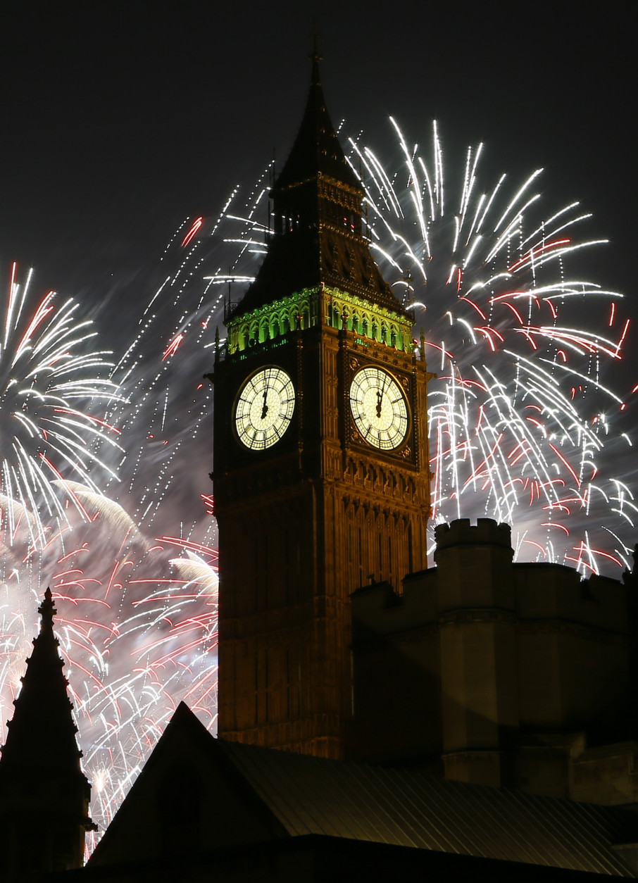 Fireworks explode over the clock known as 'Big Ben' housed in Elizabeth Tower, to celebrate the New Year in London, Thursday, Jan. 1, 2015. (AP Photo/Kirsty Wigglesworth)