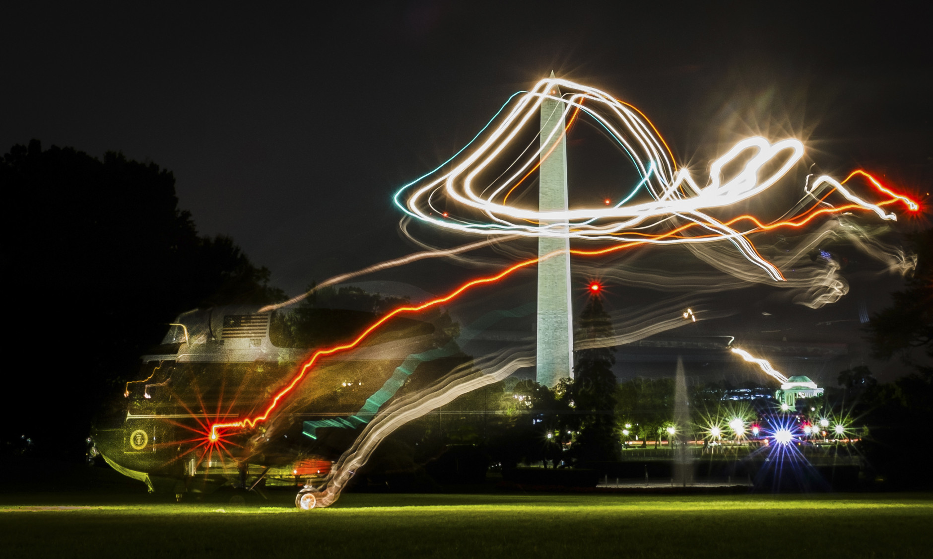 FOR USE AS DESIRED, YEAR END PHOTOS - FILE - A time exposure shows the path of Marine One as it lands on the South Lawn of the White House in Washington with President Barack Obama aboard, Thursday, July 24, 2014. (AP Photo/J. David Ake, File)