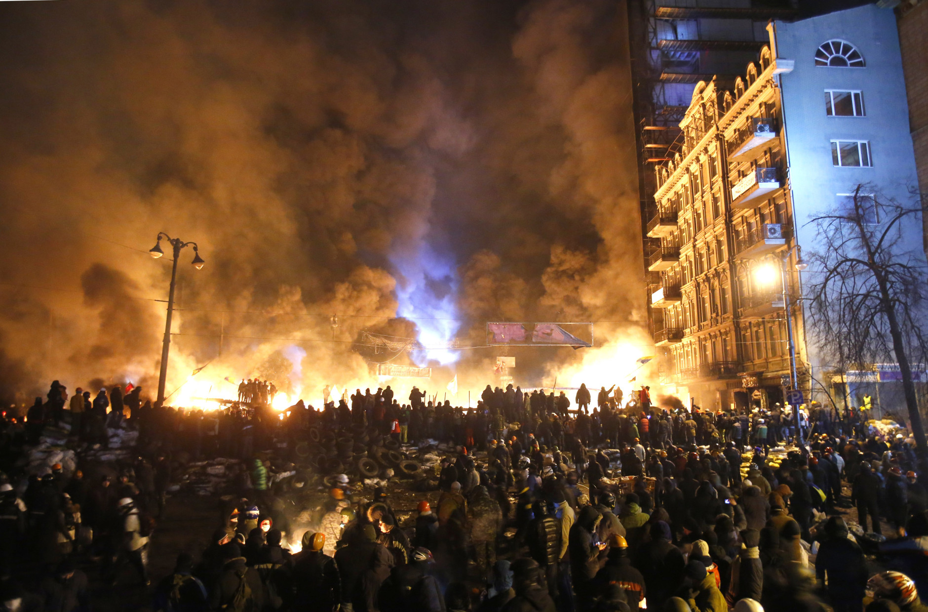 FOR USE AS DESIRED, YEAR END PHOTOS - FILE - Black smoke and fireballs rise during clashes between protesters and police in central Kiev, Ukraine, early Saturday, Jan. 25, 2014. (AP Photo/Sergei Grits, File)