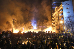 FOR USE AS DESIRED, YEAR END PHOTOS - FILE - Black smoke and fireballs rise during clashes between protesters and police in central Kiev, Ukraine, early Saturday, Jan. 25, 2014. (AP Photo/Sergei Grits, File)