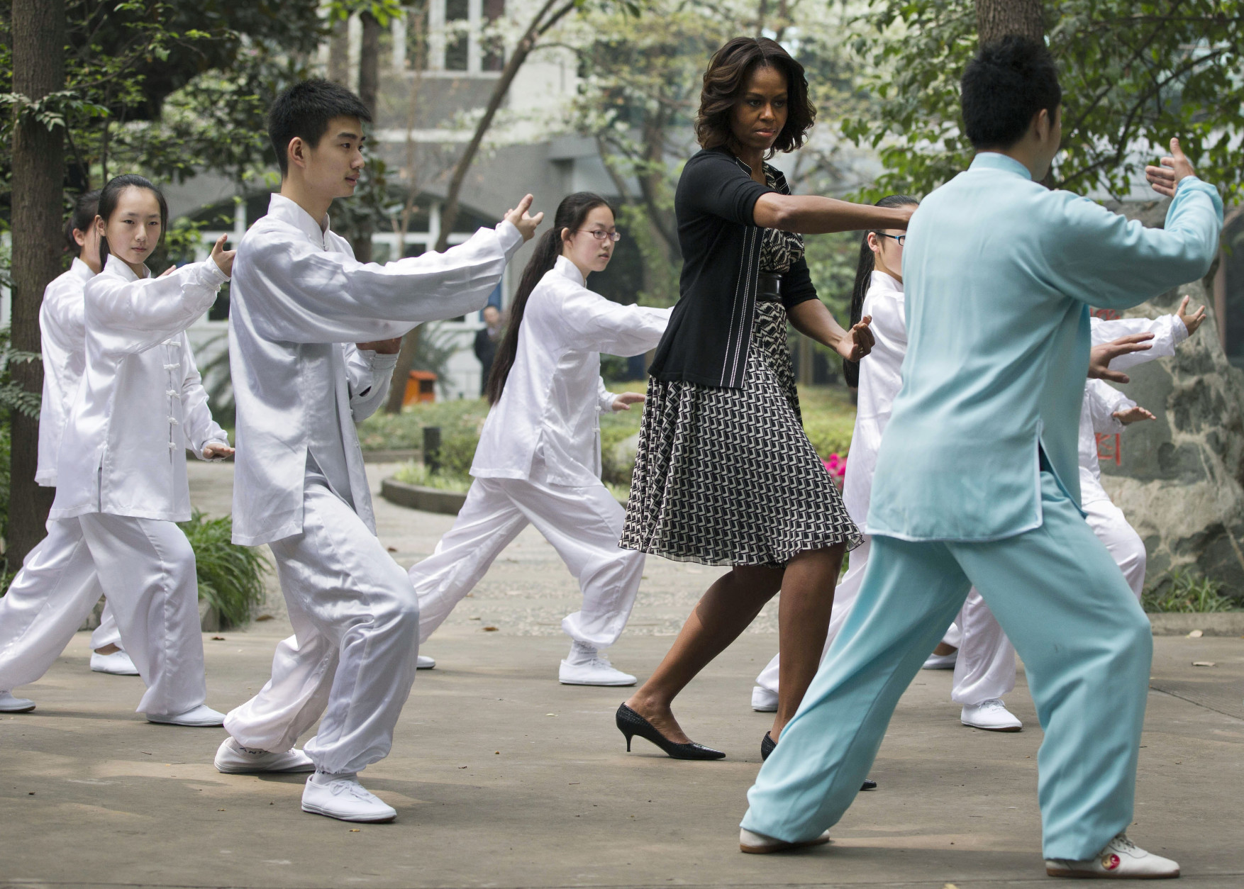 FOR USE AS DESIRED, YEAR END PHOTOS - FILE - U.S. first lady Michelle Obama practices tai chi with students at Chengdu No.7 High School in Chengdu in southwest China's Sichuan province Tuesday, March 25, 2014. (AP Photo/Andy Wong, File)