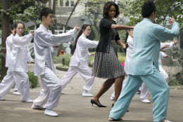 FOR USE AS DESIRED, YEAR END PHOTOS - FILE - U.S. first lady Michelle Obama practices tai chi with students at Chengdu No.7 High School in Chengdu in southwest China's Sichuan province Tuesday, March 25, 2014. (AP Photo/Andy Wong, File)