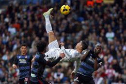 FOR USE AS DESIRED, YEAR END PHOTOS - FILE - Real Madrid's Cristiano Ronaldo, of Portugal, top, tries to score in between opposition players during a Spanish La Liga soccer match between Real Madrid and Granada at the Santiago Bernabeu stadium in Madrid, Spain, Saturday, Jan. 25, 2014. (AP Photo/Andres Kudacki, File)