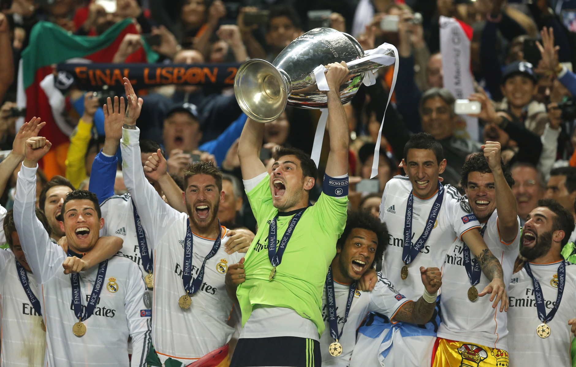FOR USE AS DESIRED, YEAR END PHOTOS - FILE - Real goalkeeper Iker Casillas, center, lifts the Champion League trophy, as he and teammates, celebrate winning the Champion League title, against Atletico Madrid, in Lisbon, Portugal, Saturday, May 24, 2014.  (AP Photo/Andres Kudacki, File)