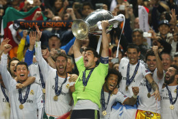FOR USE AS DESIRED, YEAR END PHOTOS - FILE - Real goalkeeper Iker Casillas, center, lifts the Champion League trophy, as he and teammates, celebrate winning the Champion League title, against Atletico Madrid, in Lisbon, Portugal, Saturday, May 24, 2014.  (AP Photo/Andres Kudacki, File)