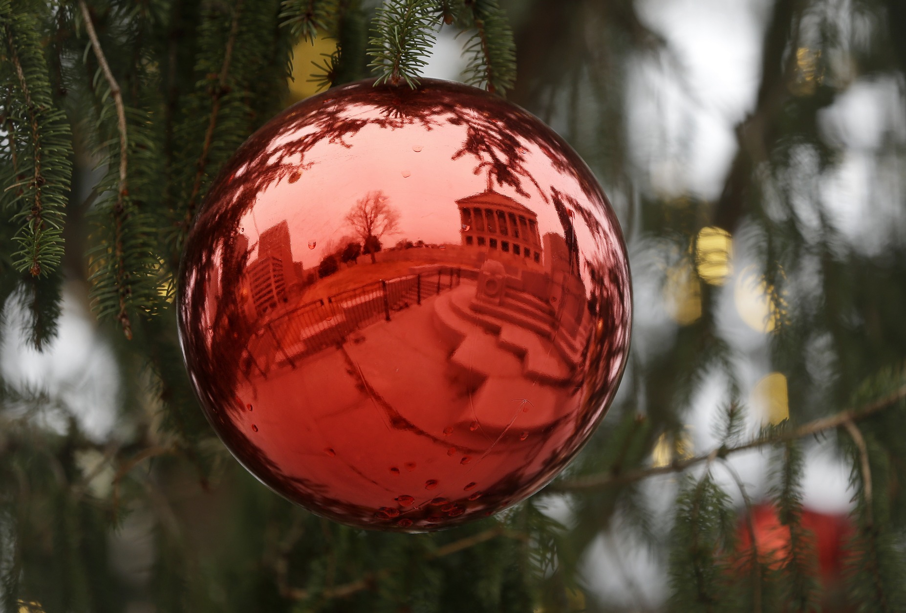 The capitol is reflected in an ornament on the state Christmas tree Thursday, Dec. 18, 2014, in Nashville, Tenn. (AP Photo/Mark Humphrey)